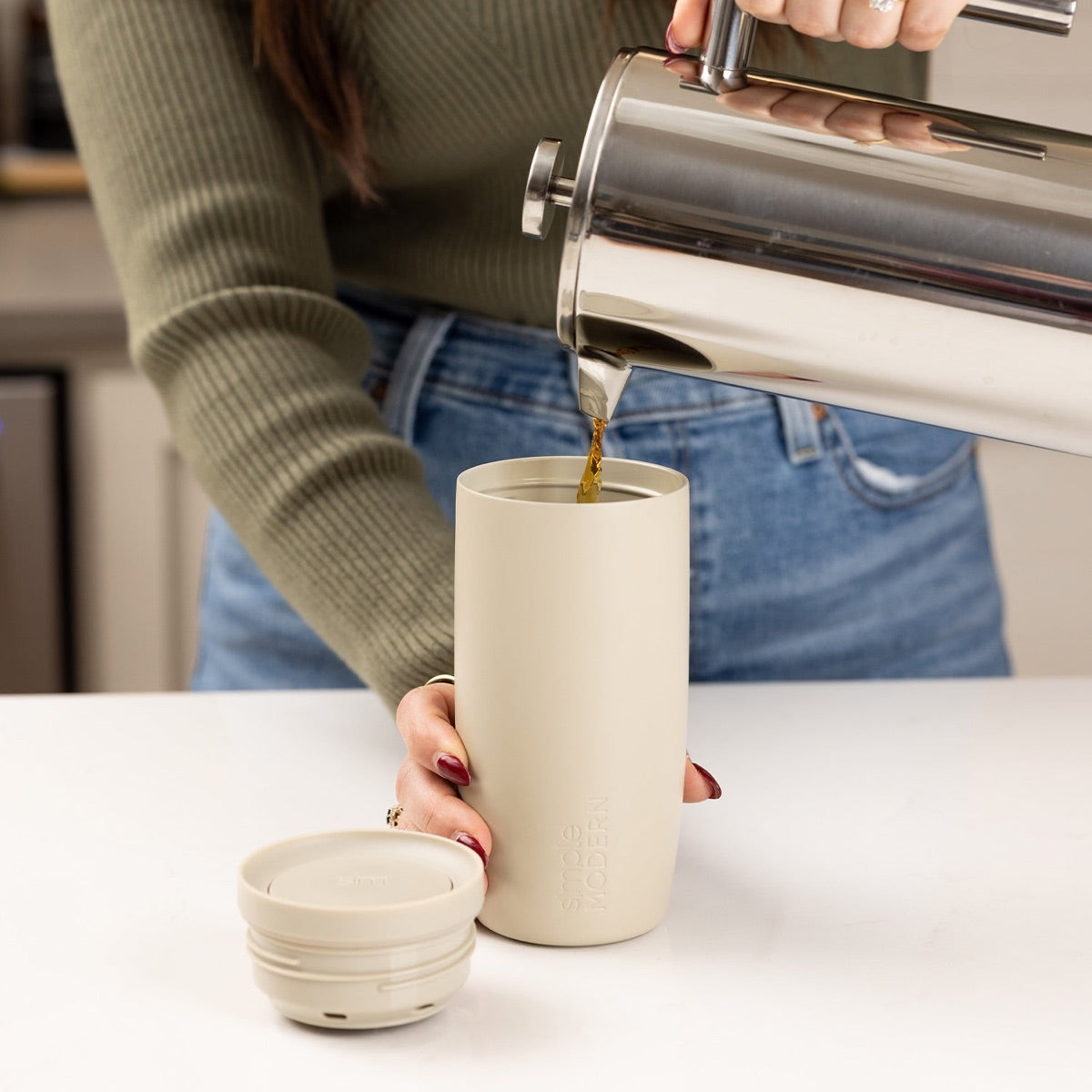 Coffee poured into a travel tumbler